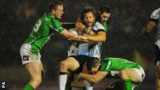 Fiji's Ashton Sims is tackled by three Irish defenders