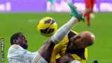 Swansea's Nathan Dyer clashes with Liverpool keeper Pepe Reina