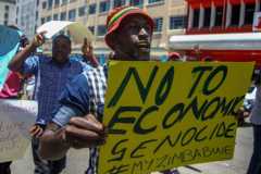 Zimbabwean opposition Movement for Democratic Change (MDC) supporters shout political slogans and hold placards during a protest against the Zimbabwean government on May 28, 2016 in Bulawayo.
