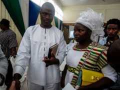 Evangelical preacher Emmanuel Momoh arrives with his wife on May 11, 2017 in Freetown for the auction of the 709 carats diamond he found earlier this year