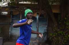 A man holds rocks in both hands as weapons