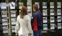 People looking in estate agent's window
