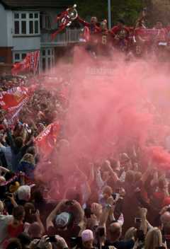 Liverpool defender Dejan Lovren holds the European Champion Club's Cup trophy over crowds