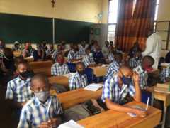 Students in Remera public school sitting two per desk