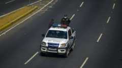 Police patrol the empty streets in El Salvador's capital during the coronavirus pandemic, 23 March 2020