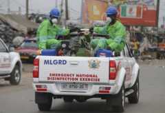 Men in a truck sent to disinfect a market in Accra, Ghana