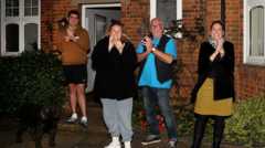 People clapping outside home