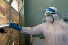 Man looking out of window at Wilkins Hospital in Zimbabwe
