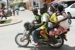 People on a motorbike taxi in Uganda