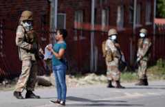 A soldier inspects paperwork in South Africa
