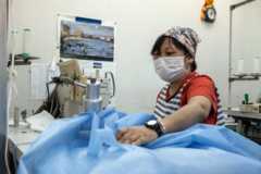 A worker makes a medical gown in the Riviere garment factory amid a nationwide shortage of personal protective equipment on May 14, 2020 in Sakai, Japan.