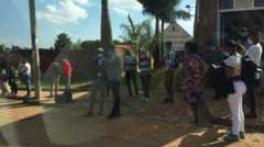 Commuters at a bus stop in Kigali on 5 May, 2020