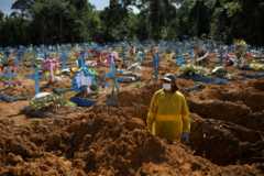 A gravedigger works at the Parque Taruma cemetery amid the coronavirus outbreak in Manaus, Brazil, December 31, 2020.