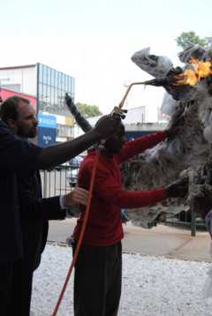 Officials burn the plastic rhino sculpture
