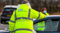 Test and Trace worker puts a test through a car window