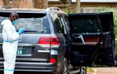 Forensic experts secure the scene of an attempted assassination on Ugandan minister of works and transport General Katumba Wamala