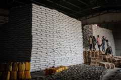 Workers carry sacks of wheat from stocks for a food distribution for 4503 people, who fled the violence in Ethiopia's Tigray region