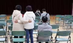 People comfort each other in a community centre in Seoul
