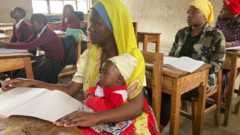 Esnath Gideon with her baby in class, Mbeya region, Tanzania