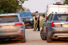 A Royal Canadian Mounted Police (RCMP) officer arrives at a crime scene after multiple people were killed and injured in a stabbing spree in Weldon, Saskatchewan