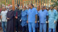 Medical staff stand next to the bodies of Palestinians killed in Israeli strikes, amid the ongoing conflict between Israel and Palestinian Islamist group Hamas, at Nasser hospital in Khan Younis, in the southern Gaza Strip, December 20, 2023.
