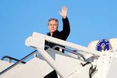Antony Blinken waves just before he enters an aircraft en route to Saudi Arabia