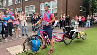 Luke Grenfell Shaw and his pink-and-blue tandem bicycle named "Chris"