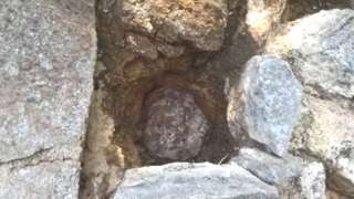 A cannon ball lodged in a wall