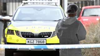 Police car and forensic officer