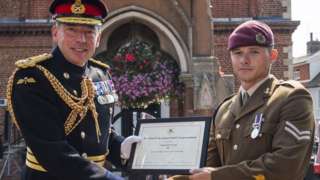 Cpl Joe Lovell (r) was presented his award by Lt Col Simon Carvel (l) in Woodbridge, Suffolk.