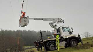 Workers repair electricity lines
