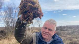 Peter Harper holding a clump of healthy sphagnum moss
