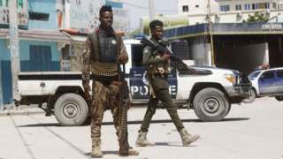 Police officers stand guard near Hayat Hotel, the scene of an al Qaeda-linked al Shabaab group militant attack, in Mogadishu