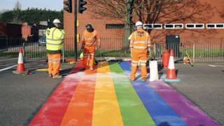 Rainbow crossing and highway workers
