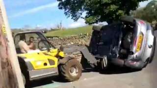 An image issued by the Crown Prosecution Service from video played at Durham Crown Court showing Charlie Burns, a friend of car driver Elliott Johnson, remonstrating with farmer Robert Hooper after he used a farm vehicle to remove a Vauxhall Corsa from his land