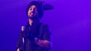 Diljit Dosanjh performs on stage during the Born To Shine World Tour in Vancouver in June 2022