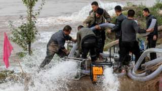 Rescue teams pump water at flooded Jiexiu Fenhe wetland park in Jinzhong, Shanxi Province of China.
