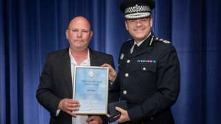 Adrian Henefer receiving a good citizen award