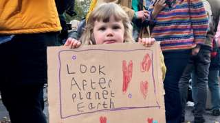 child with climate banner
