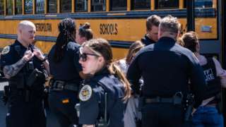 School buses with children arrive at Woodmont Baptist Church to be reunited with their families after a mass shooting at The Covenant School on March 27, 2023 in Nashville, Tennessee.