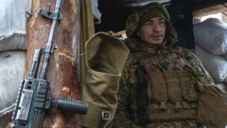 A Ukrainian soldier patrol the frontline in Zolote, Ukraine