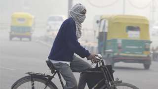 A man cycles to work amid smog and cold weather, near Shanti Van, on 24 November 2020 in Delhi, India