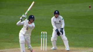 Durham batsman Keaton Jennings drives to the cover boundary, watched by Warwickshire wicketkeeper Tim Ambrose