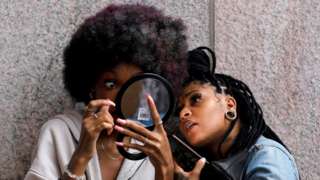 A model prepares backstage at Harlem Fashion Week in Manhattan, New York City, U.S., September 5, 2021