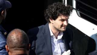 Sam Bankman-Fried being helped out of a vehicle