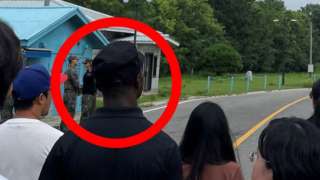Travis King (wearing black shirt and black cap) on the border between the two Koreas, 18 July 2023