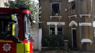A fire engine parked in front of the house where the explosion happened.