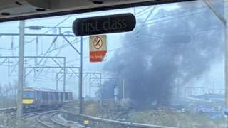 Thick smoke clouds near a rail track