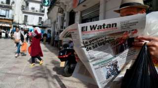 A man reads an Algerian French-language newspaper in Algiers