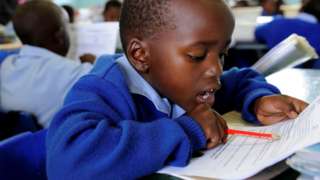 A child reading an exam sheet.